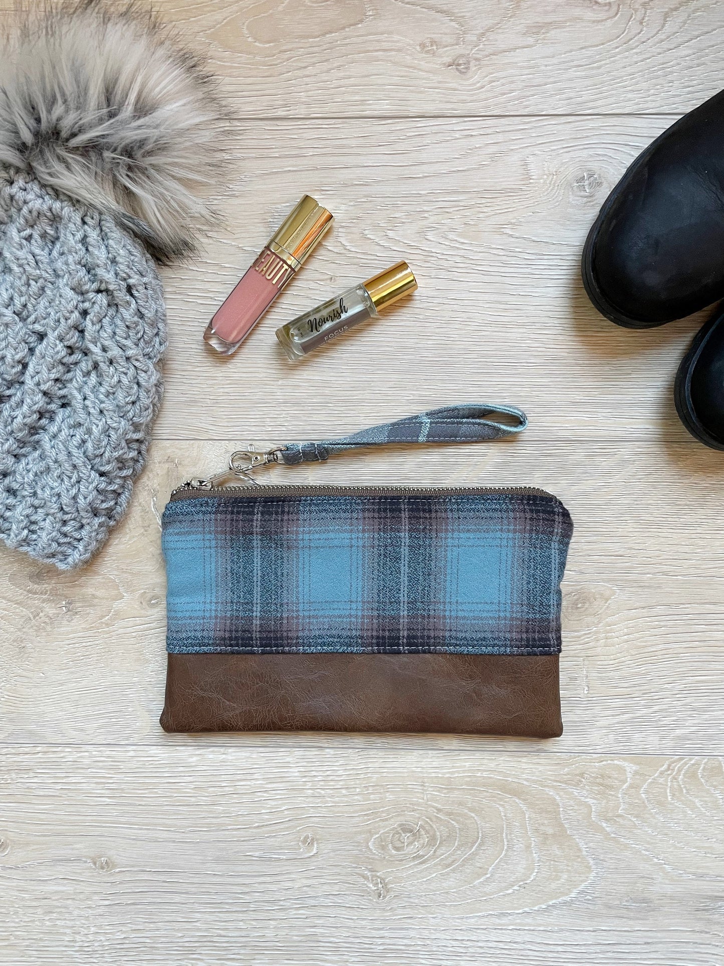 blue black and brown flannel wristlet with brown vinyl bottom. matching wrist strap 