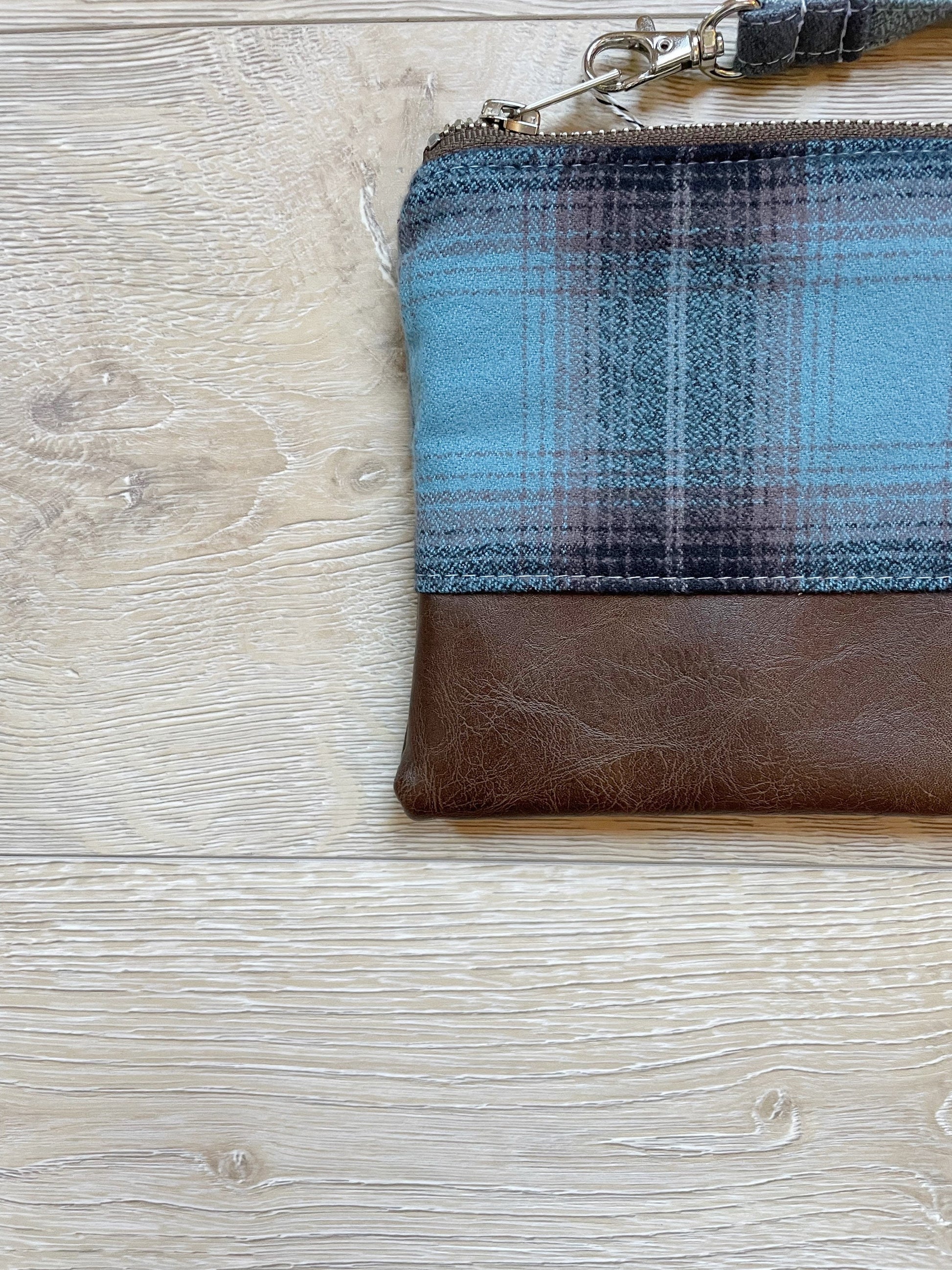 blue black and brown flannel wristlet with brown vinyl bottom. matching wrist strap 